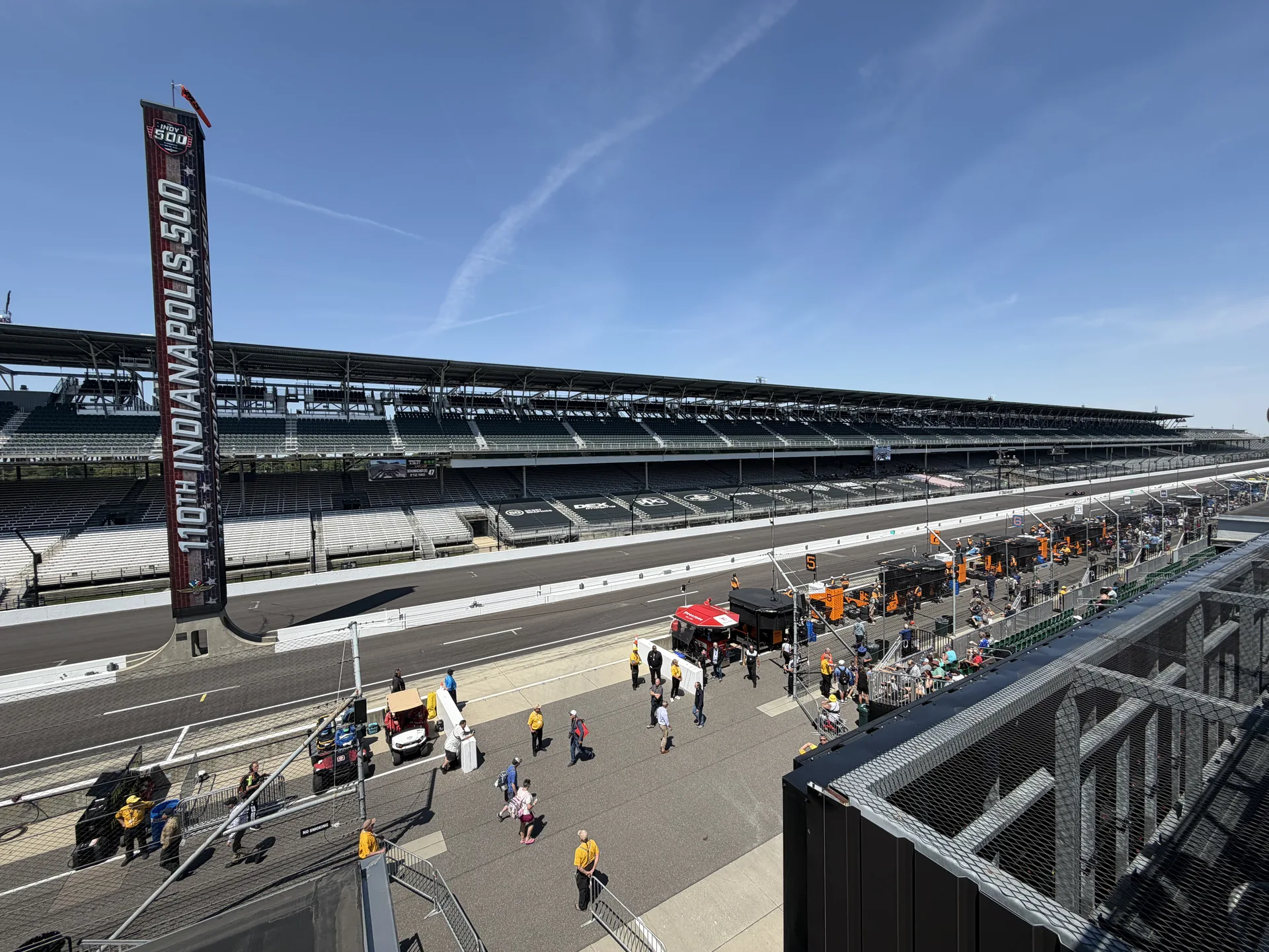 Pit lane view at Indianapolis Motor Speedway with the 110th Indianapolis 500 pylon and grandstands