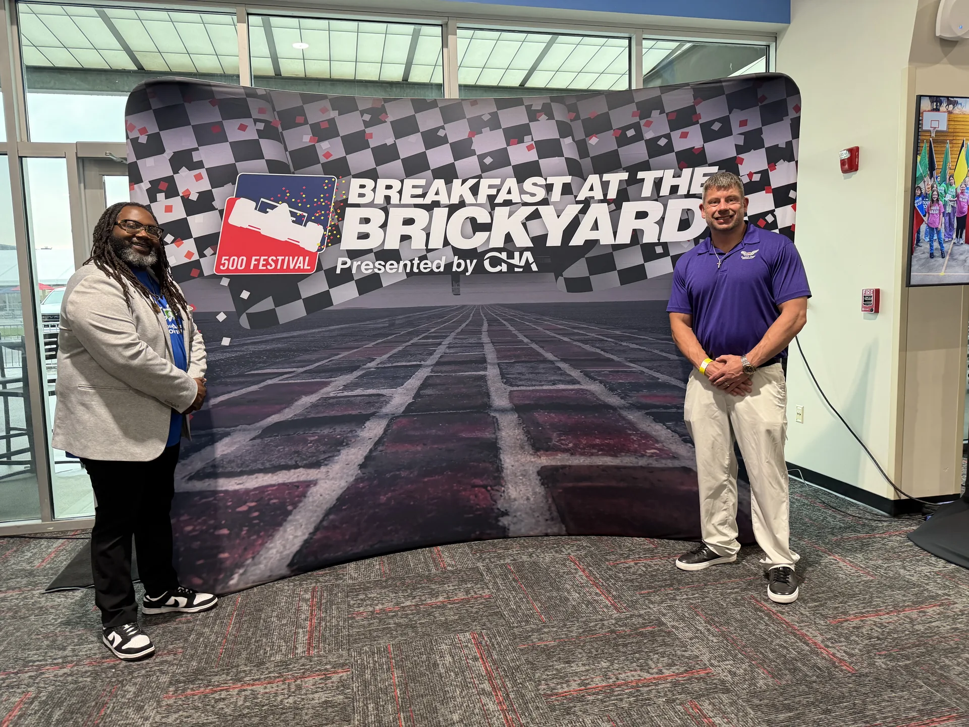 Guardian Angel Restoration team relaxed pose at the 500 Festival Breakfast at the Brickyard step and repeat