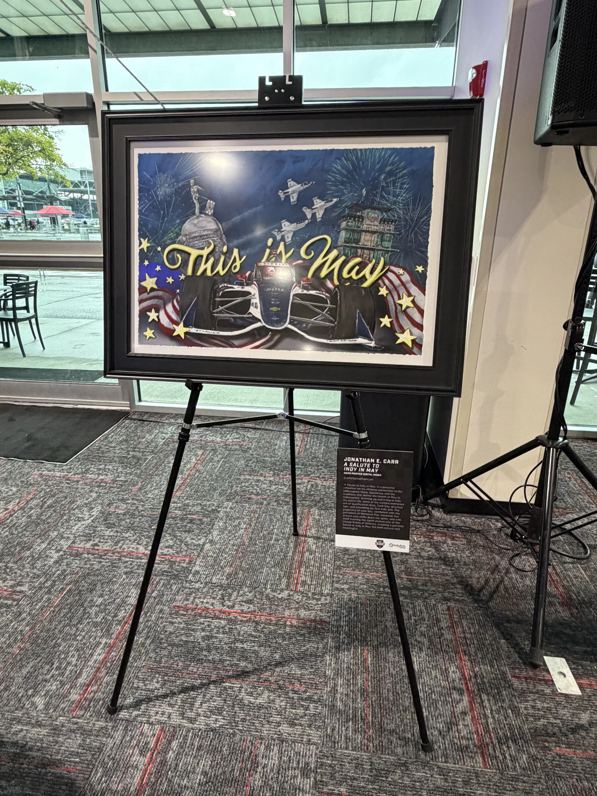 Indy 500 art piece by Jonathan Chan featuring a race car at sunset on display at the Brickyard breakfast