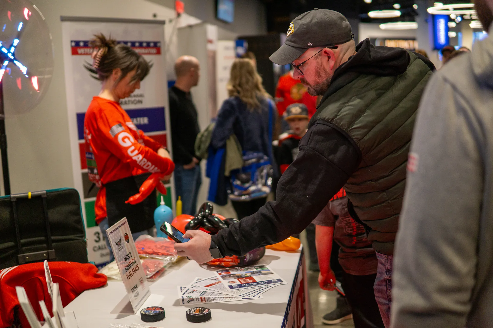 Guardian Angel crew making balloon animals at the booth