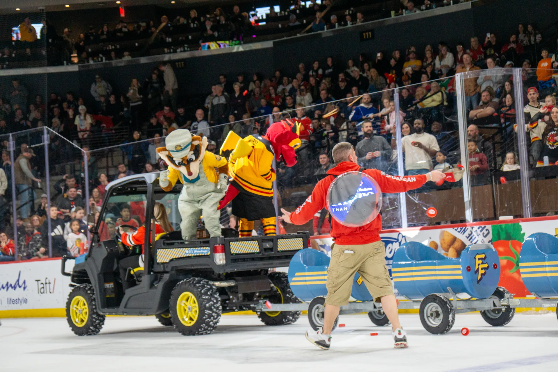 Guardian Angel crew on the ice throwing prizes to the crowd at Fishers Event Center