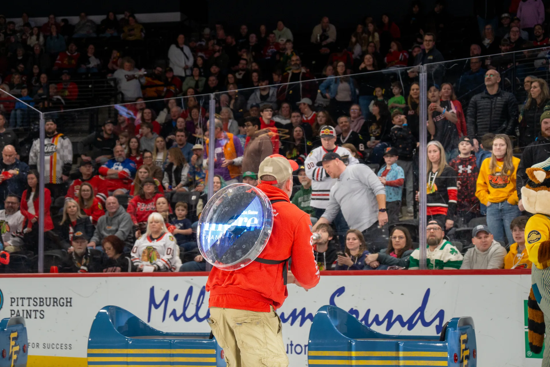 Guardian Angel crew member with shield sign at the glass during ice promotion
