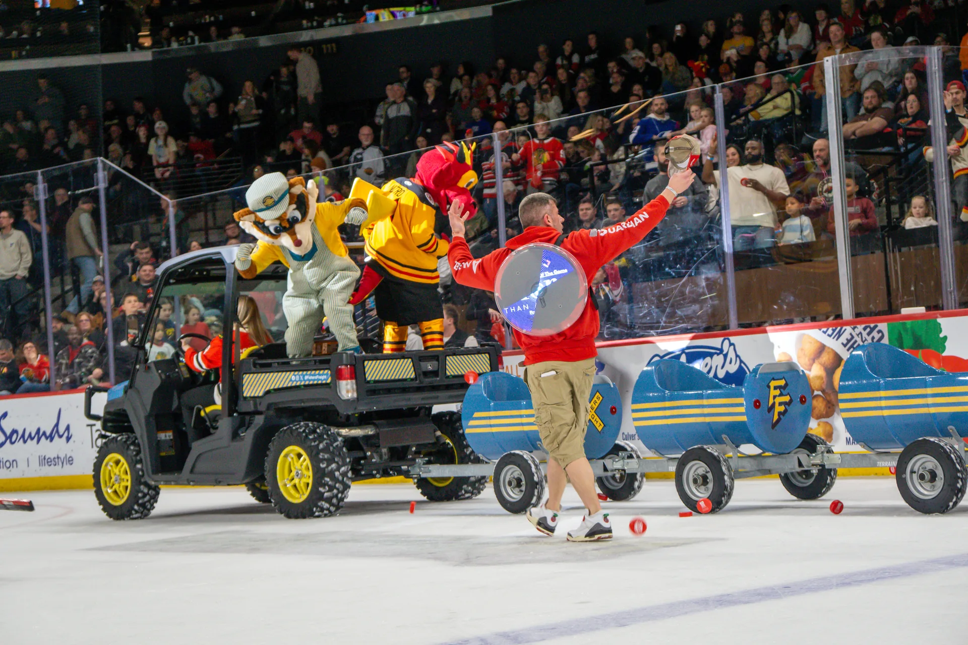 Indy Fuel mascot at the glass with crowd during Guardian Angel on-ice promotion