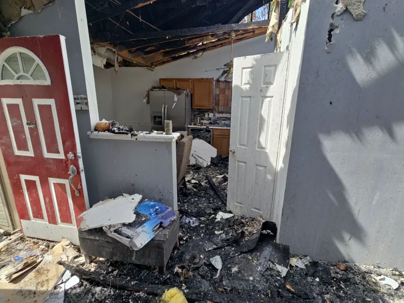 Fire-damaged kitchen with charred cabinetry and soot-stained ceiling in an Indianapolis residential property requiring Guardian Angel fire damage restoration
