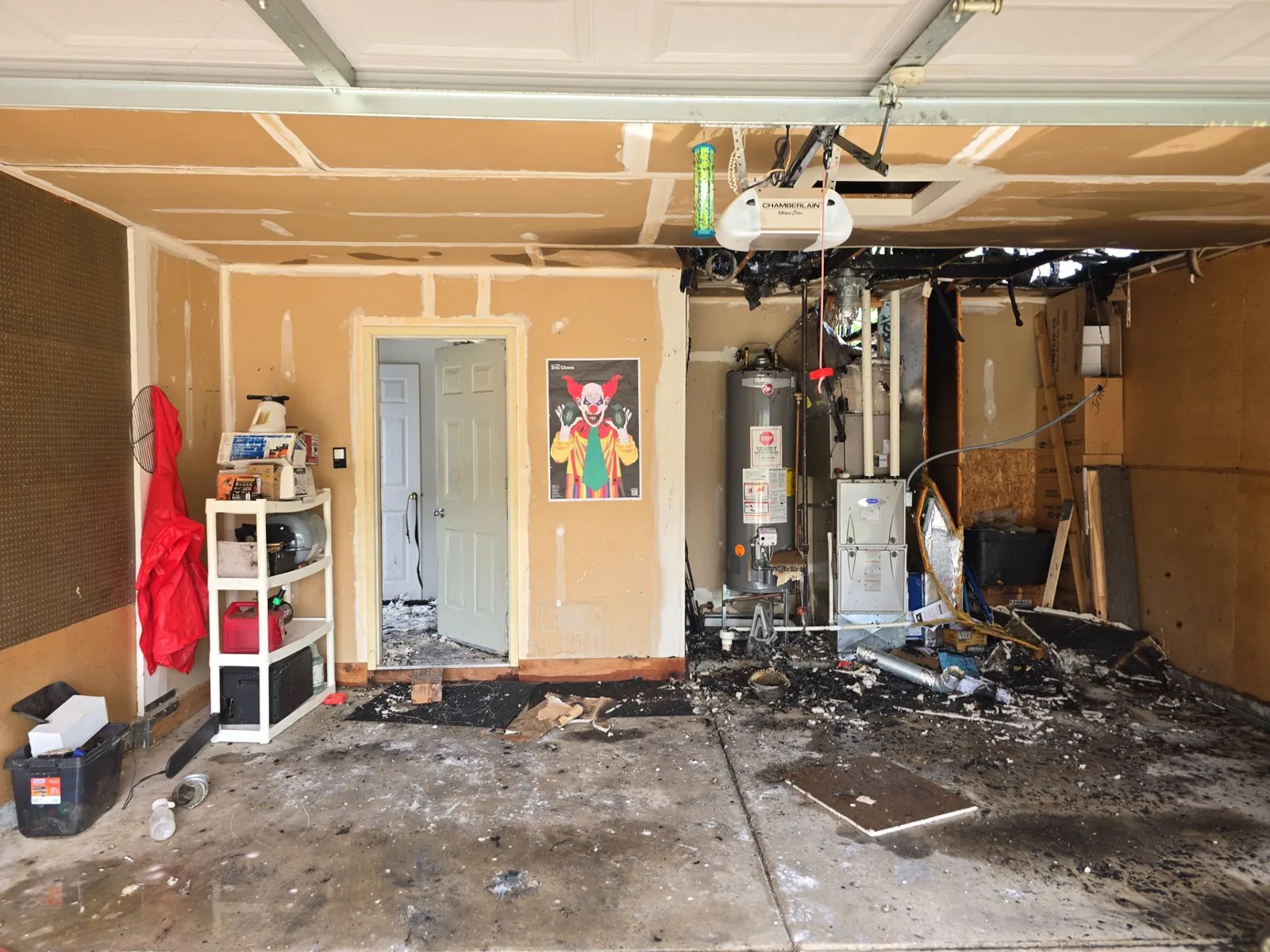 Garage with charred ceiling framing above the furnace and water heater where the fire started.