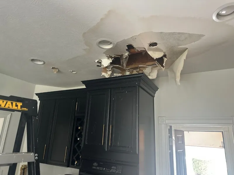 Water damage through a kitchen ceiling &mdash; a common emergency in Indianapolis pre-1940 homes with aging galvanized plumbing above finished living spaces